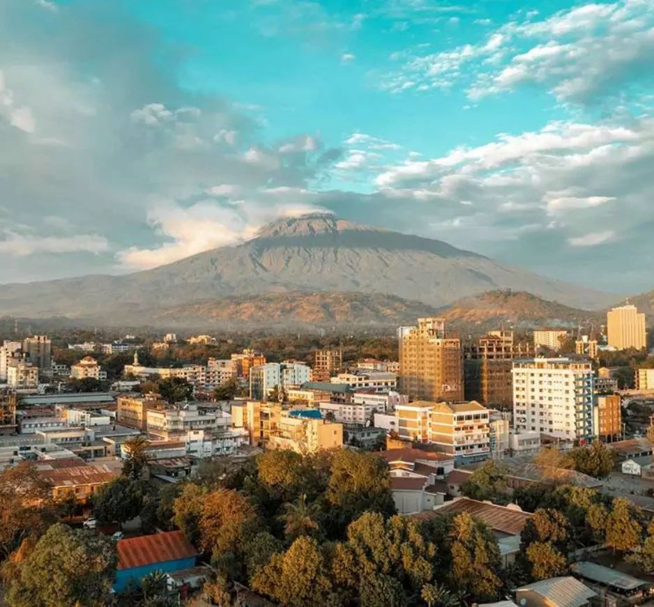 Arusha at golden hour with Mount Meru behind the rooftops